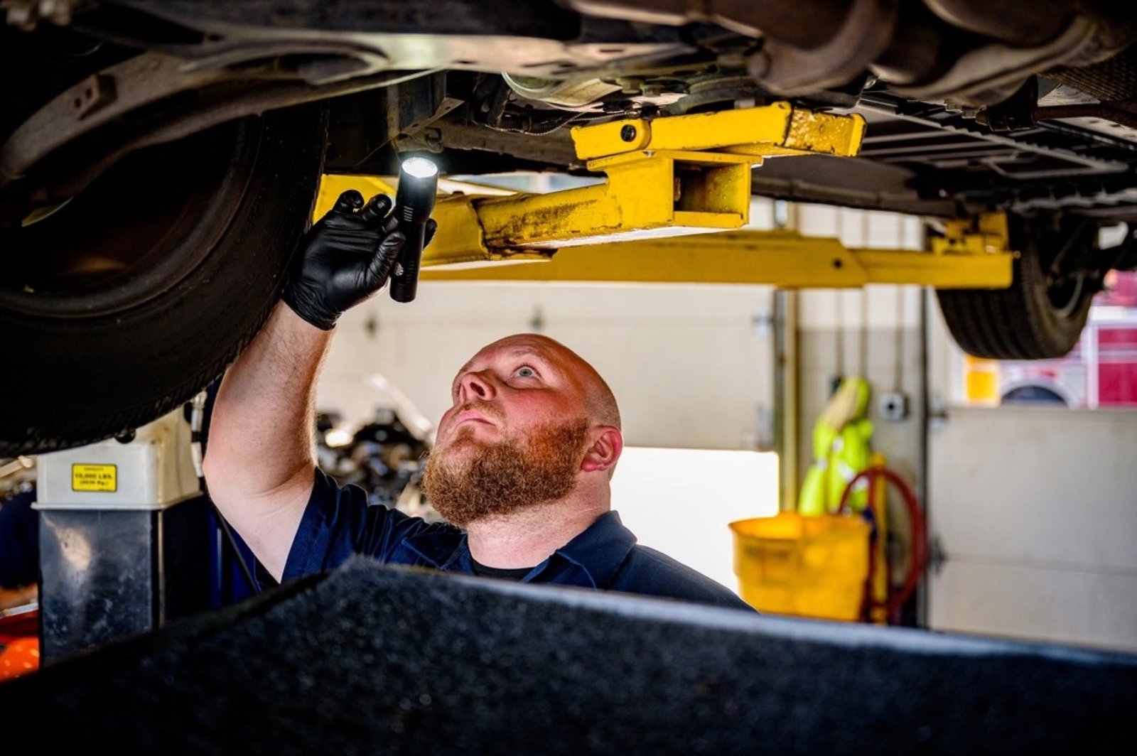 Technician servicing a vehicle at Master Touch